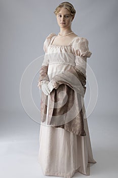 A young Regency woman in a pink dress and pearl necklace photo