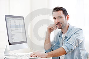 Young relaxed man using computer