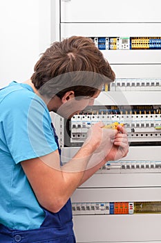 Young repairman checking voltage