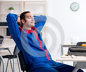 Young repairman repairing air-conditioner at warranty center