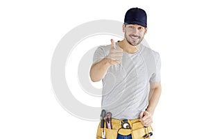 Young repairman with tool belt giving thumb up