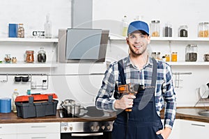 young repairman in uniform on blurred