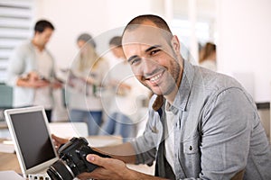 Young reporter working at office on laptop