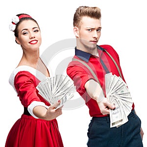 Young retro couple holding money