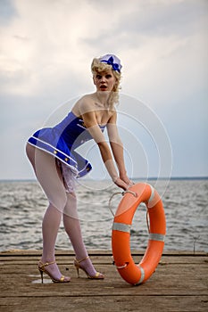 Young retro pinup girl with blond curly hair style and beau