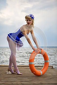 Young retro pinup girl with blond curly hair style and beau