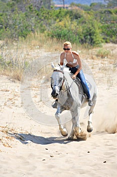 Young rider on the beach