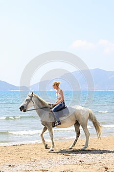 Young rider on the beach