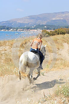 Young rider on the beach