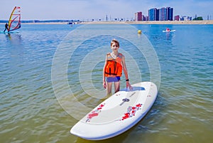 A young rider on a board for Sap surfing rakes a wave with a paddle, the concept of an active lifestyle