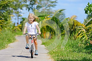 Young rider kid in riding bicycle