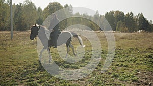 A young rider sets off early in the morning on a long horse ride through rough terrain and woods.