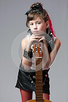 Young rocker posing with guitar