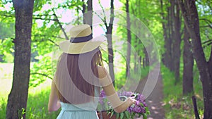 Young romantic beautiful traveler girl with hat and dress with retro vintage bicycle sunset forest