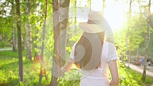 Young romantic beautiful woman with hat and white dress with retro vintage bicycle in sunset forest