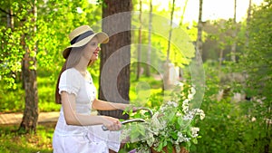 Young romantic beautiful woman with hat and white dress with retro vintage bicycle in sunset forest