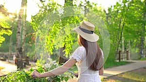 Young romantic beautiful woman with hat and white dress with retro vintage bicycle in sunset forest