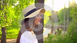 Young romantic beautiful woman with hat and white dress with retro vintage bicycle in sunset forest