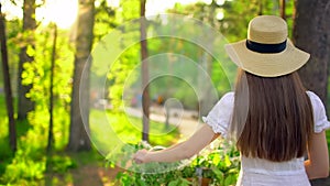 Young romantic beautiful woman with hat and white dress with retro vintage bicycle in sunset forest