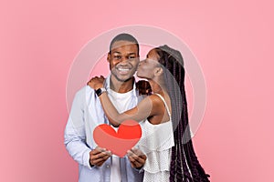 Young Romantic Black Couple Kissing And Holding Red Paper Heart