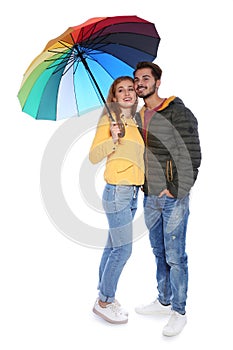 Young romantic couple with bright umbrella