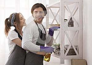 Young Romantic Couple Doing Housework At Home Together, Hugging And Smiling