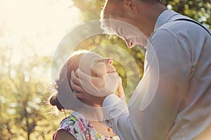 Young romantic couple flirting in sunshine. Vintage love