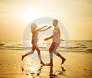 Young, romantic couple hugging on the tropical beach