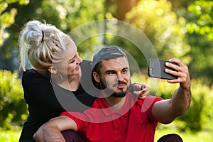Young romantic couple making selfie outdoors
