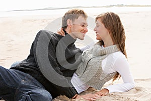 Young Romantic Couple Relaxing On Beach Together