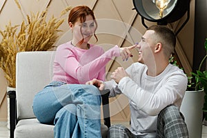 Young romantic couple smiling looking at each other indoors