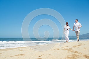 Young romantic couple walking on the beach