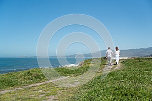 Young romantic couple walking on the trail holding hands