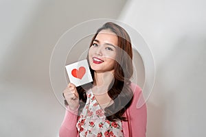 Young romantic girl with Valentines card