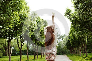 Young romantic woman dancing with flowers