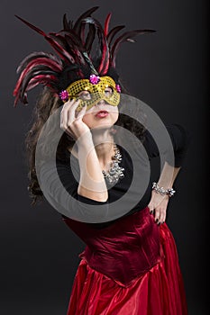 Young romany woman posing on carnaval with mask