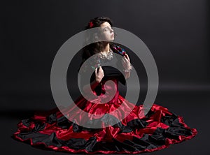 Young romany woman sit in spanish traditional clothes