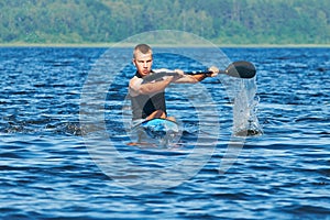 The young rower's training on the racing kayak