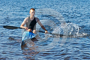 The young rower's training on the racing kayak