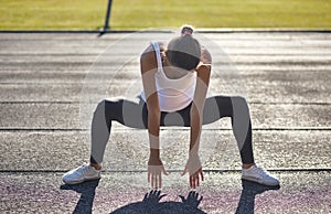 Young runner fit woman streching before exercises outdoors. Athletic female strech after workout outside. Sport and