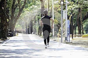 Young runner man jogging in the morning  doing exercise outdoor  hansom sport male jogger athlete doing workout in garden park