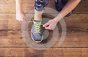 Young runner tying her shoes