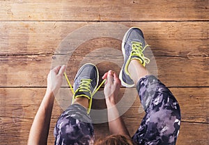 Young runner tying her shoes