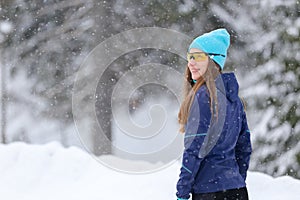 Young runner woman standing in park in winter