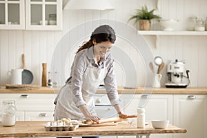 Young 35s Hispanic woman prepare pastries in the kitchen photo