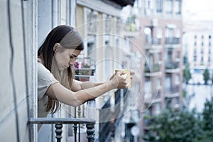 Young sad beautiful woman suffering depression looking worried and wasted on home balcony