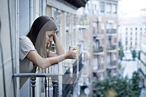 Young sad beautiful woman suffering depression looking worried and wasted on home balcony