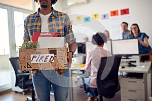 A young sad clerk leaves the office after being fired. Employees, job, office