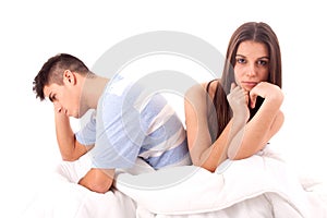 A young sad couple in bed having problems and cris