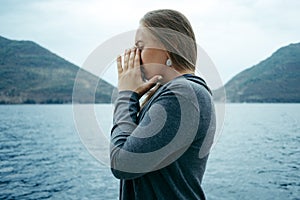 Young sad Crying woman near the sea with the horizon in the bac